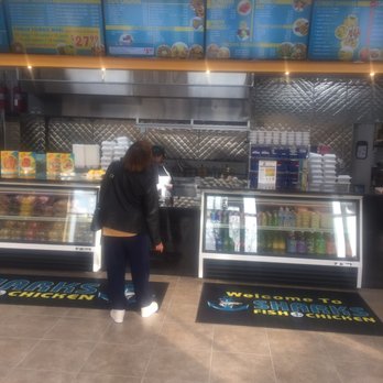 Sharks Fish And Chicken - a woman standing in front of a display case - Chicken Wings Near Me - Gary, Indiana Sharks Fish And Chicken - a woman standing in front of a display case - Chicken Wings Near Me - Gary, Indiana