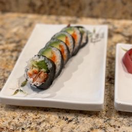 two plates of sushi on a granite countertop