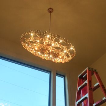 Smart Synergy - Installing high-end luxurious luminaries, approximate height is 24ft. two stories, use of proper floor protection and polishing of glass. - Electricians Near Me Smart Synergy - Installing high-end luxurious luminaries, approximate height is 24ft. two stories, use of proper floor protection and polishing of glass. - Electricians Near Me