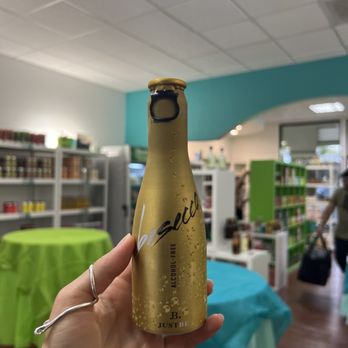 Herban Flow - a hand holding a bottle of beer - Beverage Store Near Me - St. Petersburg, Florida