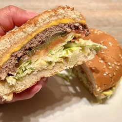 Nogales Burgers - Cheeseburger. Beef patty, tomatoes, onions, cheese, lettuce, and thousand island sauce on a toasted bun. A great burger to try out!