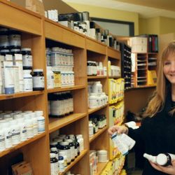 Oregon Regenerative Medicine - Patient Care Coordinator Caryn with the many supplements offered at Oregon Regenerative Medicine