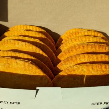 Patties Express - A dozen patties basking in the sunshine: spicy (left) and non-spicy (right) - Caribbean Near Me - Newmarket, Ontario