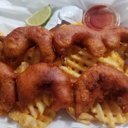 Delicious beer battered shrimp and waffle fries Delicious beer battered shrimp and waffle fries
