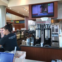 a woman working at a coffee shop a woman working at a coffee shop