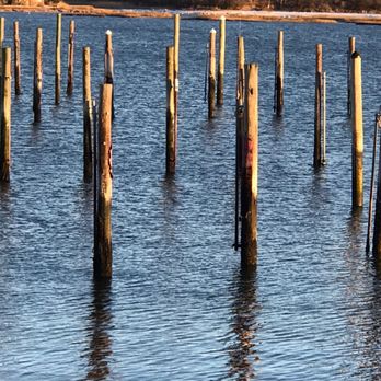 Sunsets at Cedar Beach - a row of poles in the water - American Near Me - Mount Sinai, New York Sunsets at Cedar Beach - a row of poles in the water - American Near Me - Mount Sinai, New York