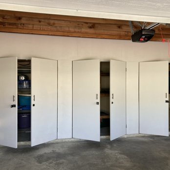 Tixan Construction - Custom size garage storage building.
Wooden wall separating storage from garage space, framing + 6 doors installation. - General Contractors Near Me