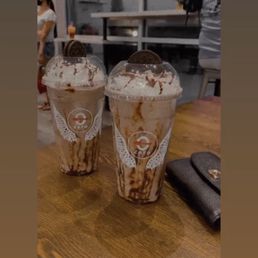 two glasses of iced coffee on a table two glasses of iced coffee on a table