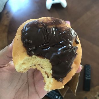 Dunkin' -  a hand holding a half eaten donut - Donuts Near Me - Jacksonville, North Carolina