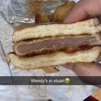 Wendy's - a hand holding a half eaten sandwich - Fast Food Near Me - Quinton, Virginia