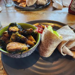 The chicken wrap with a side of Brussels Sprouts instead of fries. Under $10.00 in 2023. The chicken wrap with a side of Brussels Sprouts instead of fries. Under $10.00 in 2023.