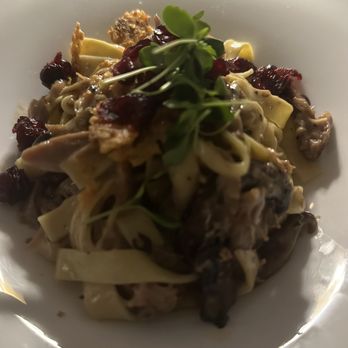 Fauna - Duck - A serving of pasta with a variety of toppings, including microgreens and dried berries, presented on a white plate. The dish appears to include pasta noodles, possibly with a sauce or seasoning, and is garnished with fresh microgreens for visual contrast. - New American Near Me - Westhampton Beach, New York