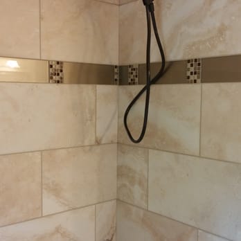 Abraham Tile - a shower with a shower head - Flooring Near Me - Tigard, Oregon