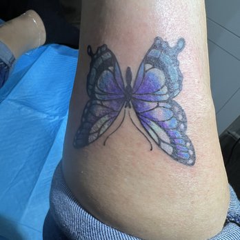 Blue Heart Tattoo - My daughters back leg, beautiful butterfly - Tattoo Near Me - Traverse City, Michigan