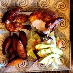 Pollo Bravo - Half chicken with fried sweet plantains, and avocado salad.