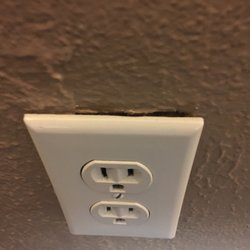 Light cover sticking out from wall and big crack around it