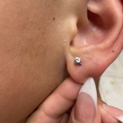 Piercing Pagoda - The second time she pierced the same ear she still missed the mark.