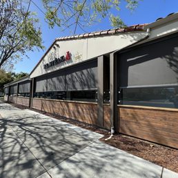 Exterior outside entrance of Falcon Comfort Home Solutions - 10 motorized 6% providing shade, wind, and splash protection for restaurant patrons - El Monte, California Exterior outside entrance of Falcon Comfort Home Solutions - 10 motorized 6% providing shade, wind, and splash protection for restaurant patrons - El Monte, California
