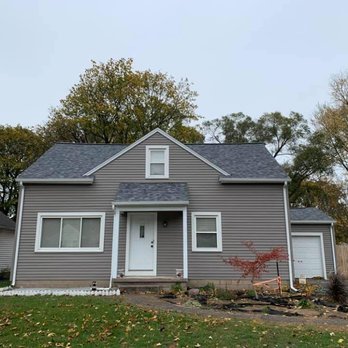 Five Star Improvements Finger Lakes - a two - story house with gray siding and white trim - Roofing Near Me - Canandaigua, New York Five Star Improvements Finger Lakes - a two - story house with gray siding and white trim - Roofing Near Me - Canandaigua, New York