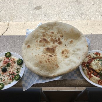 Golden Laffa - three plates of food on a table - Mediterranean Near Me - Toronto, Ontario Golden Laffa - three plates of food on a table - Mediterranean Near Me - Toronto, Ontario