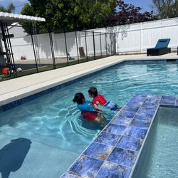 Sun Rays Swim Academy - Teacher Becky helping her student get comfortable with the water!