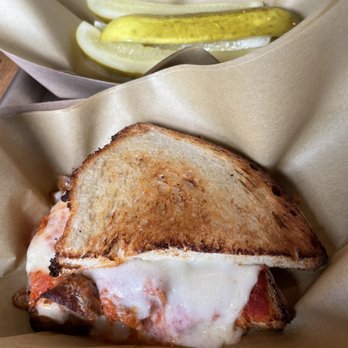Fiala Brothers - Pickle Spears and the delicious Meatball Parm-- note that this is the full portion, looks to be a half sandwich - Brewpubs Near Me - Normal, Illinois