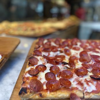 Unregular Pizza - a pepperoni pizza on a cutting board - Pizza Near Me - New York, New York