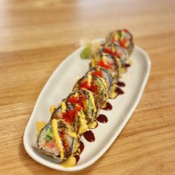 Ekiben Japanese Kitchen - Dune Devil Roll - Spicy tuna tembettered, avocado, Jalapeño, Cilantro. Topped with Red Tobiko, spicy mayo, sweet caramel soy sauce.