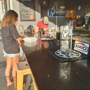 Amici Macon - Bar staff on their phone. - Chicken Wings Near Me - Macon, Georgia