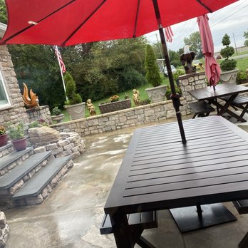 Perfect Pollo - a patio table with a red umbrella - Chicken Shop Near Me - Fredericksburg, Virginia