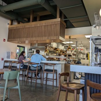Pigzza - A seating area with open view of the kitchen - Pizza Near Me - Orlando, Florida Pigzza - A seating area with open view of the kitchen - Pizza Near Me - Orlando, Florida