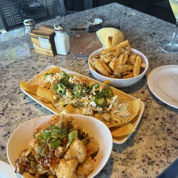 Firebirds Wood Fired Grill - Chili cauliflower, chicken nachos, and Parmesan fries. - Steakhouses Near Me - Gilbert, Arizona