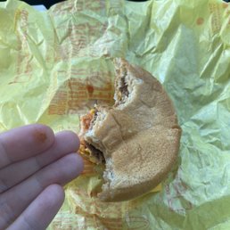 a half eaten sandwich in a wrapper
