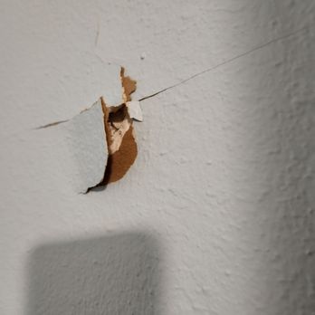 Shugarman's Bath - Hole in our bedroom wall from the shower demolotion. - General Contractors Near Me - San Diego, California