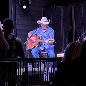 Haute Spot - Mark Chesnutt playing on guitar, center stage. - Venues & Event Spaces Near Me - Cedar Park, Texas