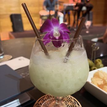 MO Bar + Lounge - a cocktail with a purple flower - Lounges Near Me - Miami, Florida