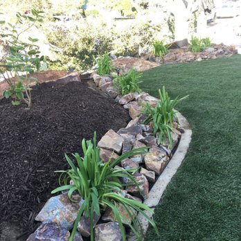 AG Lawn Care Service - a garden bed with rocks and plants - Landscaping Near Me AG Lawn Care Service - a garden bed with rocks and plants - Landscaping Near Me