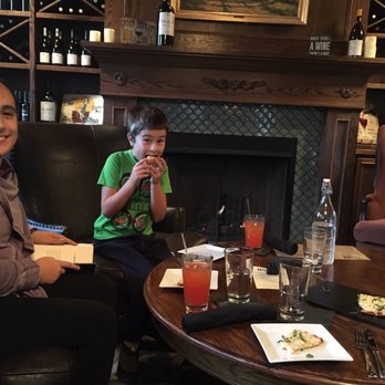 The Mill At Seventh - Fireplace and wine wall view from our spot... kids are enjoying themselves as you can see! - New American Near Me - Lynden, Washington The Mill At Seventh - Fireplace and wine wall view from our spot... kids are enjoying themselves as you can see! - New American Near Me - Lynden, Washington