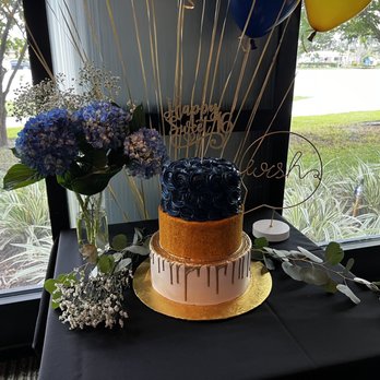 Elite Cake Creations - a three tiered cake on a table - Bakeries Near Me - Cooper City, Florida