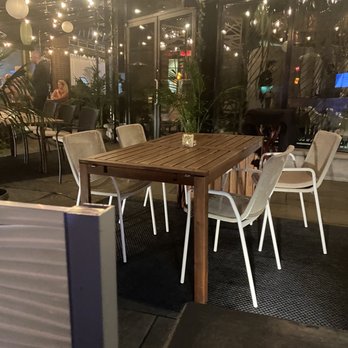 Laurie Raphaël - a table and chairs in a restaurant - French Near Me - Quebec City, Quebec Laurie Raphaël - a table and chairs in a restaurant - French Near Me - Quebec City, Quebec