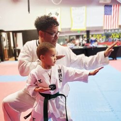 World KM Taekwondo - Celebrating Tobias earning his green belt. This kid is awesome.