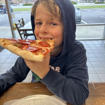 Mia Pizzeria - Pepperoni and sausage by the slice, very happy kid - Pizza Near Me - Indianapolis, Indiana Mia Pizzeria - Pepperoni and sausage by the slice, very happy kid - Pizza Near Me - Indianapolis, Indiana
