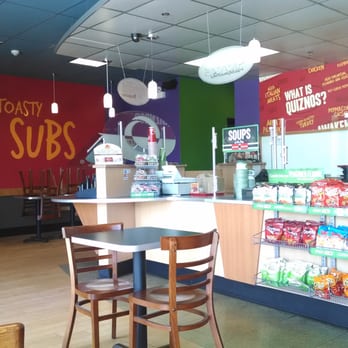 Quiznos - the inside of a restaurant with tables and chairs - Sandwiches Near Me - Barrington, Illinois