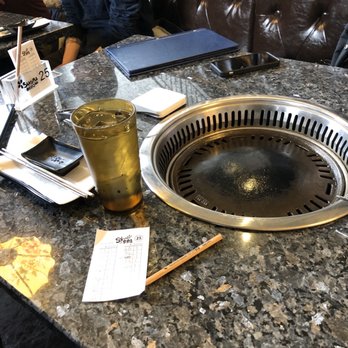 Sakura BBQ Coréen - a woman sitting at a table - Sushi Bars Near Me - Quebec City, Quebec Sakura BBQ Coréen - a woman sitting at a table - Sushi Bars Near Me - Quebec City, Quebec