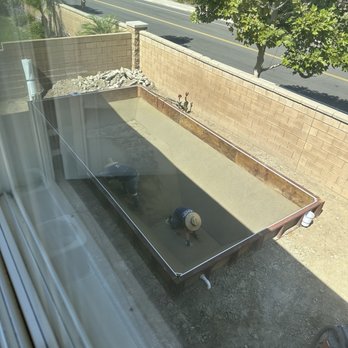 Secard Pools & Spas - The crew masterfully applying and smoothing sand along the walls and base to create an even finish. - Hot Tub & Pool Near Me - Rancho Cucamonga, California Secard Pools & Spas - The crew masterfully applying and smoothing sand along the walls and base to create an even finish. - Hot Tub & Pool Near Me - Rancho Cucamonga, California