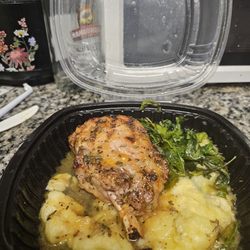 Sweet tea brined pork chop with peach glaze, mashed potatoes and spinach.