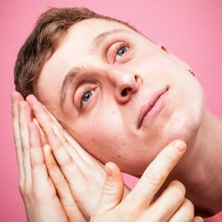 Dylan Hancook Photography - Male comedian with too many hands on pink