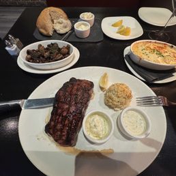 Kansas City strip with truffle butter, crab cake, wild mushrooms and I will au gratin potatoes