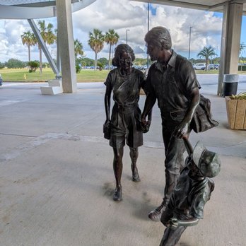 Mobile Regional Airport - Statues of a family outside the exit after exiting the baggage claim area to ground transportation. - Airports Near Me - Mobile, Alabama