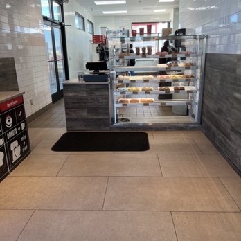 Rise + Roast - Main entry.  Not many donuts on the shelf because they're fresh and fly off the shelf quickly. - Coffee & Tea Near Me - Rio Rancho, New Mexico